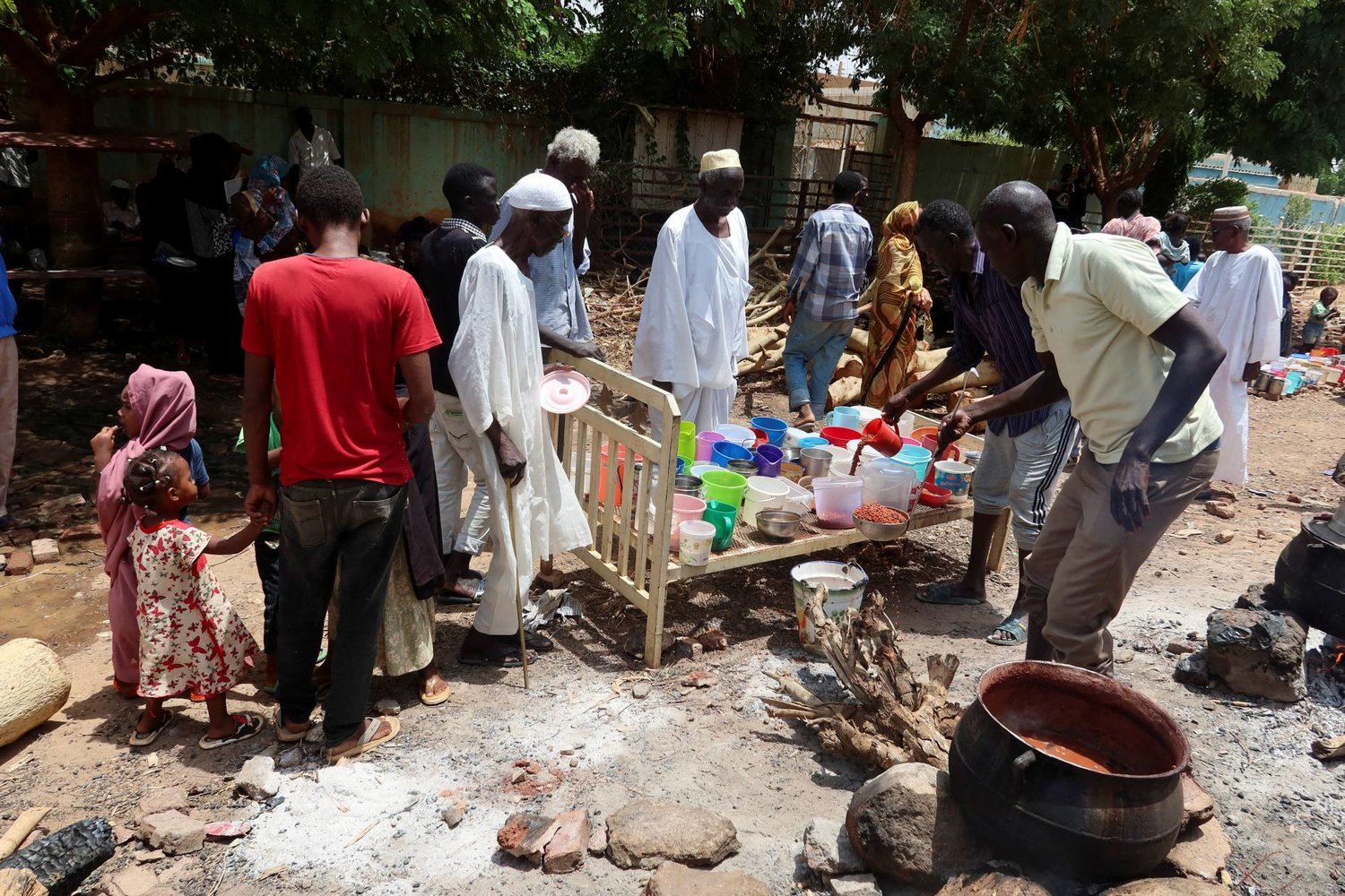 Omdurman'da gönüllülerden yiyecek almayı bekleyen vatandaşlar (Reuters)