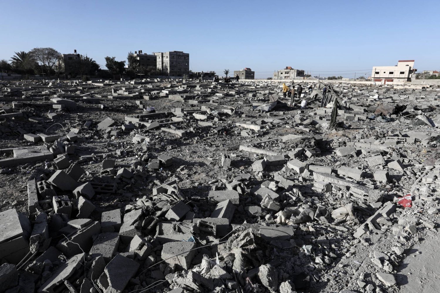 İsrail hava saldırıları sonucu yıkılan mezarları inceleyen Filistinliler (DPA)