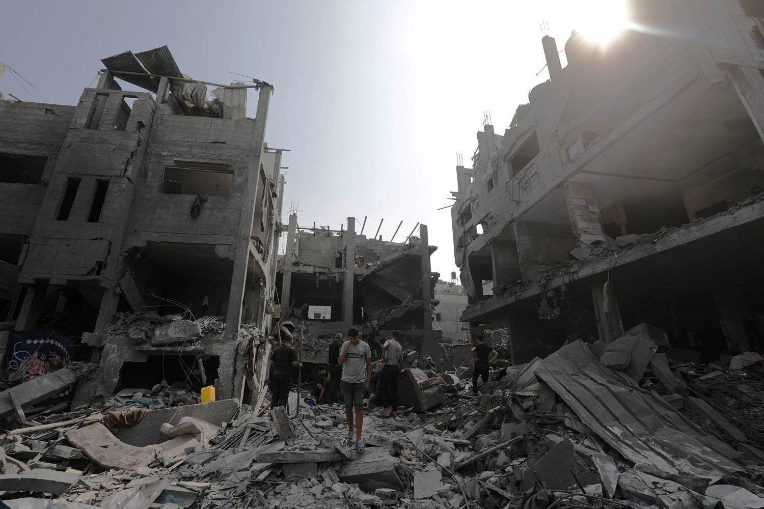 İsrail'in Gazze Şeridi'ne yönelik bombardımanının yol açtığı yıkımın ortasında kalan Filistinliler (EPA)